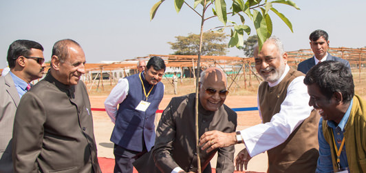 President Ramnath Govind is planting a tree at Kanha Shantivanam